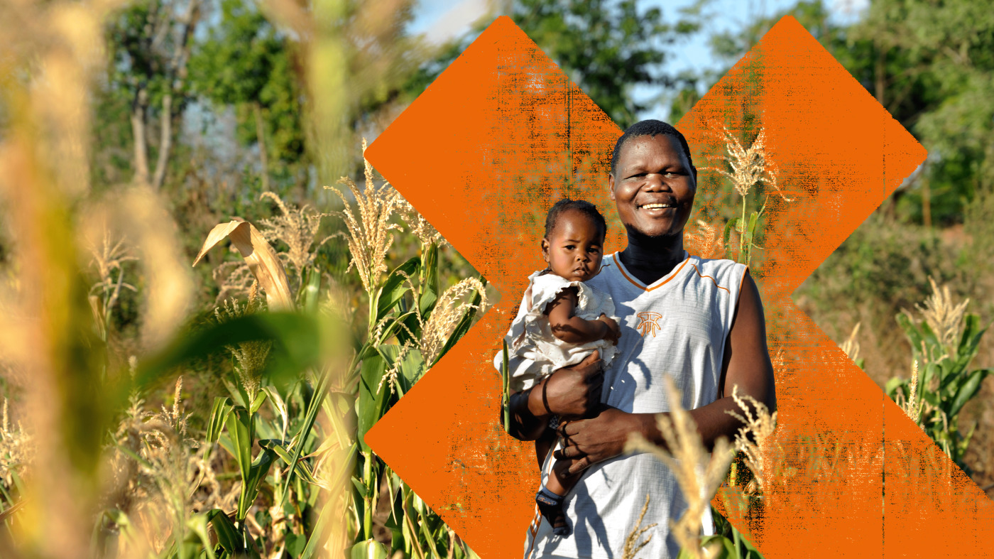 Man and child in field.